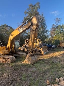 CAT excavator parked on a job site at golden hour